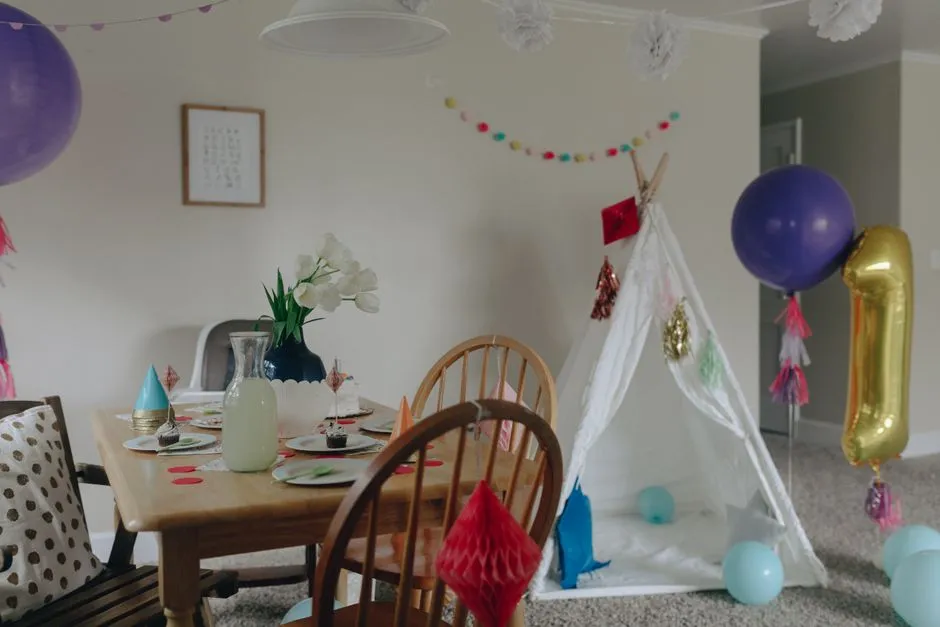 A living room set up with balloons and decorations for a kids' birthday party